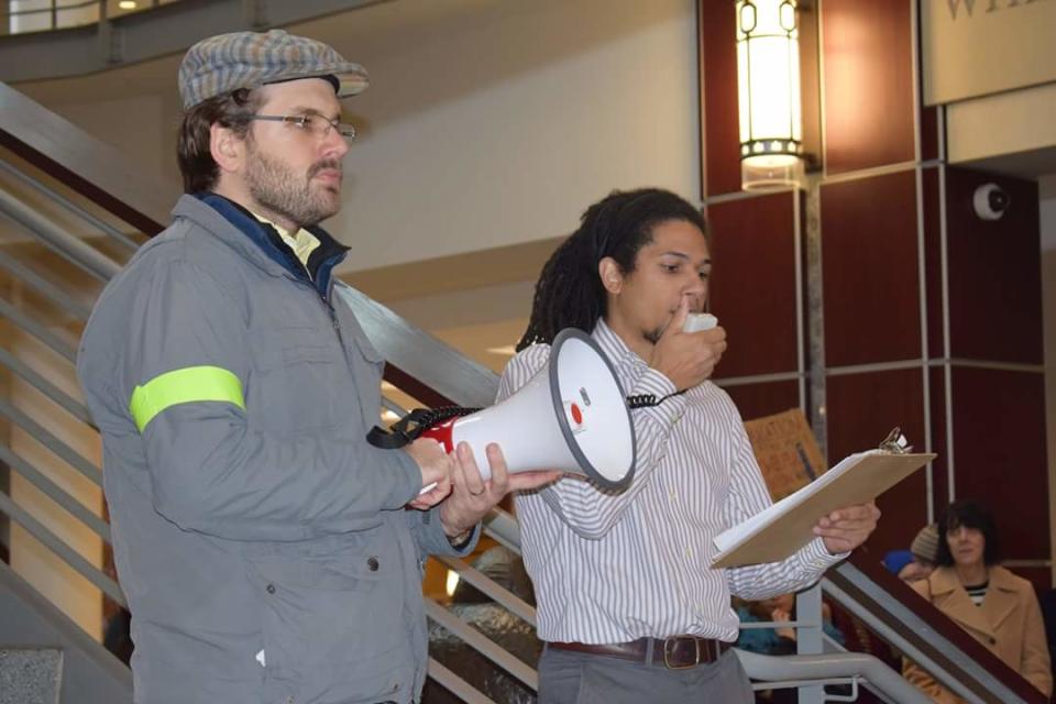 Ohio State University graduate students Alex Davis (L) and Noah Charles (R) speak at a protest against the GOP tax plan at Ohio State on Nov. 13.