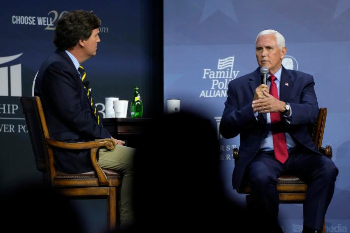 Republican presidential candidate former Vice President Mike Pence talks with moderator Tucker Carlson, left, during the Family Leadership Summit, Friday, July 14, 2023, in Des Moines, Iowa.