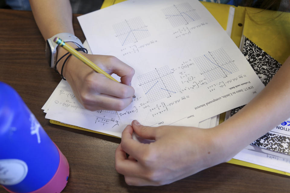 Boston Latin Academy student Lila Conley, 16, works on a pre-calculus problem during the Bridge to Calculus summer program at Northeastern University in Boston on Tuesday, Aug. 1, 2023. (AP Photo/Reba Saldanha)