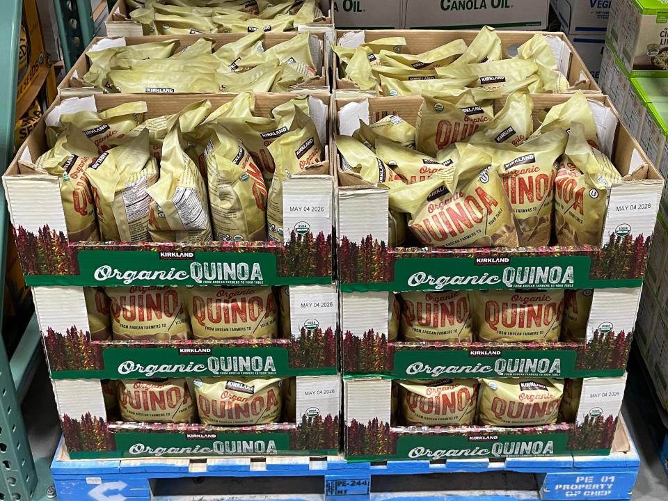 Yellow bags of quinoa in cardboard containers on pallets at Costco