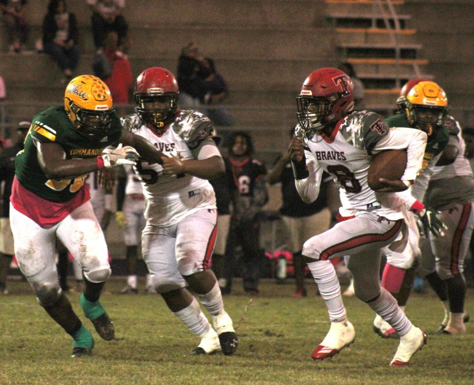 Parker quarterback Tyrek Williams (8) tries to scramble away from the Ed White defense in 2021.