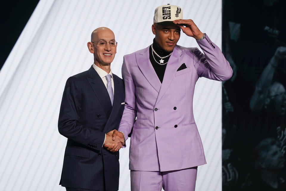 Jeremy Sochan shakes hands with NBA Commissioner Adam Silver after being selected ninth overall by the San Antonio Spurs in the NBA basketball draft, Thursday, June 23, 2022, in New York. (AP Photo/John Minchillo)