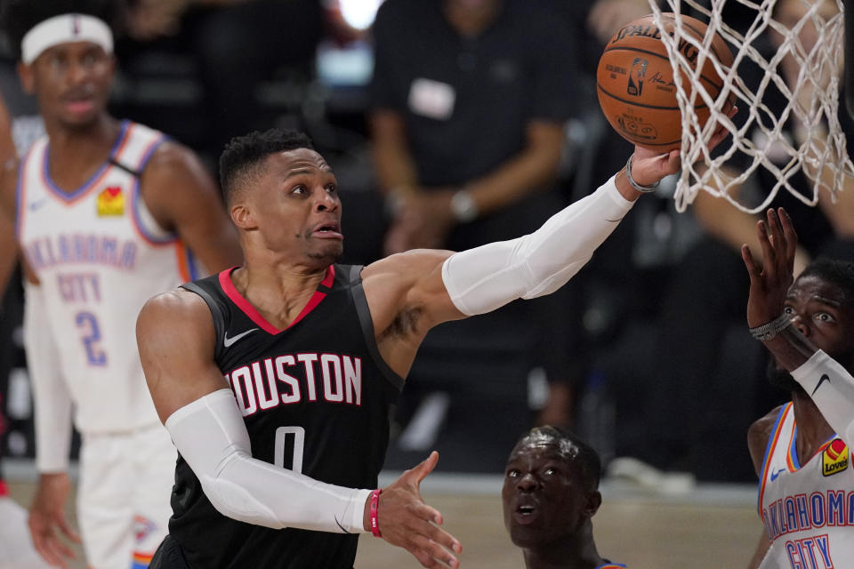 FILE - In this Wednesday, Sept. 2, 2020 file photo, Houston Rockets' Russell Westbrook (0) goes up for a shot as Oklahoma City Thunder's Nerlens Noel, right, defends during the second half of an NBA first-round playoff basketball game in Lake Buena Vista, Fla. The Houston Rockets have traded Russell Westbrook to the Washington Wizards for John Wall and a future lottery-protected. first-round pick. Both teams announced the trade Wednesday night, Dec. 2, 2020. (AP Photo/Mark J. Terrill, File)