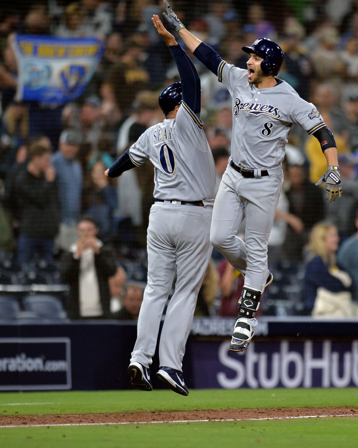 Milwaukee Brewers left fielder Ryan Braun (8) is congratulated by third base coach Ed Sedar (0) after hitting a three run home run in the ninth inning to put the Brewers ahead against San Diego on March 30, 2018.