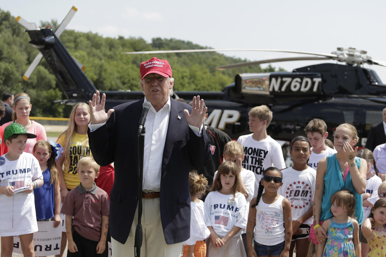 Presidential candidate Donald Trump talks to the media in Des Moines after arriving by helicopter and before attending the Iowa State Fair on Aug. 15, 2015. (Photo: Charlie Riedel/ASSOCIATED PRESS)