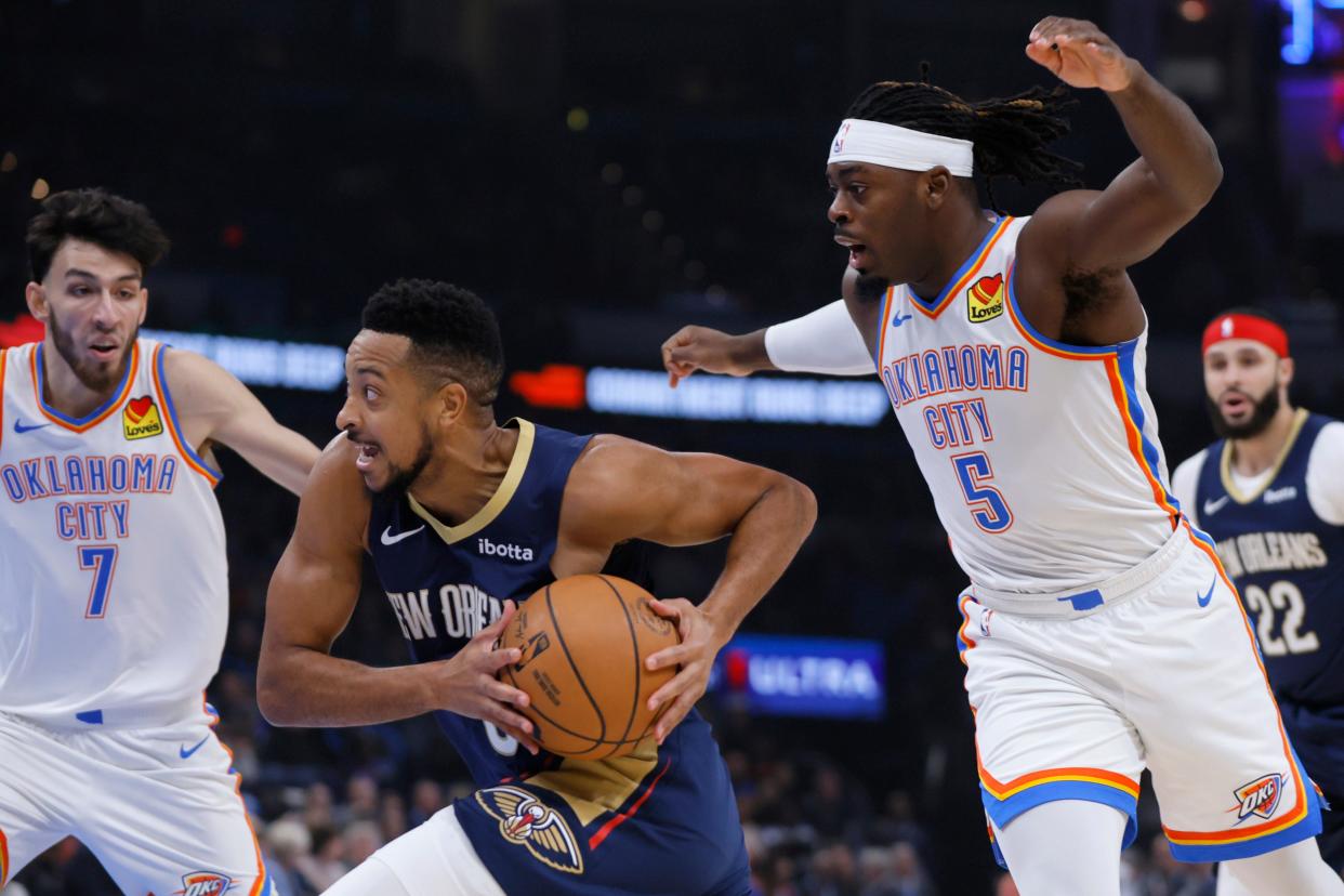 New Orleans Pelicans guard CJ McCollum (3) goes past Oklahoma City Thunder guard Luguentz Dort (5) during an NBA basketball game between the Oklahoma City Thunder and the New Orleans Pelicans at Paycom Center in Oklahoma City, Wednesday, Nov. 1, 2023. The Thunder lost 110-106.