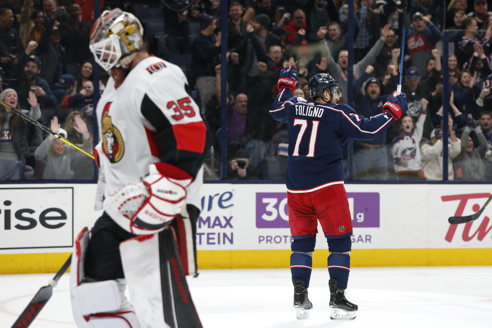 Columbus Blue Jackets' Nick Foligno, right, celebrates his goal against Ottawa Senators' Marcus Hogberg, left, of Sweden, during the second period of an NHL hockey game Monday, Feb. 24, 2020, in Columbus, Ohio. (AP Photo/Jay LaPrete)