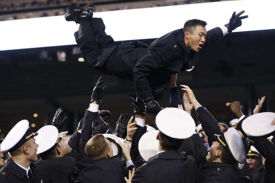 Navy midshipmen celebrate a Navy touchdown during the second half of an NCAA college football game, Saturday, Dec. 14, 2019, in Philadelphia. Navy won 31-7. (AP Photo/Matt Rourke)