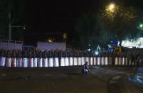 <p>Riot police secure a police station, which is being held by an armed group, in Yerevan, Armenia, early July 27, 2016. A spokesman for Armenia’s police says two of the gunmen who have been holding a police station in the capital for more than a week have surrendered after an exchange of gunfire. (Photo: Vahan Stepanyan/PAN Photo/AP)</p>