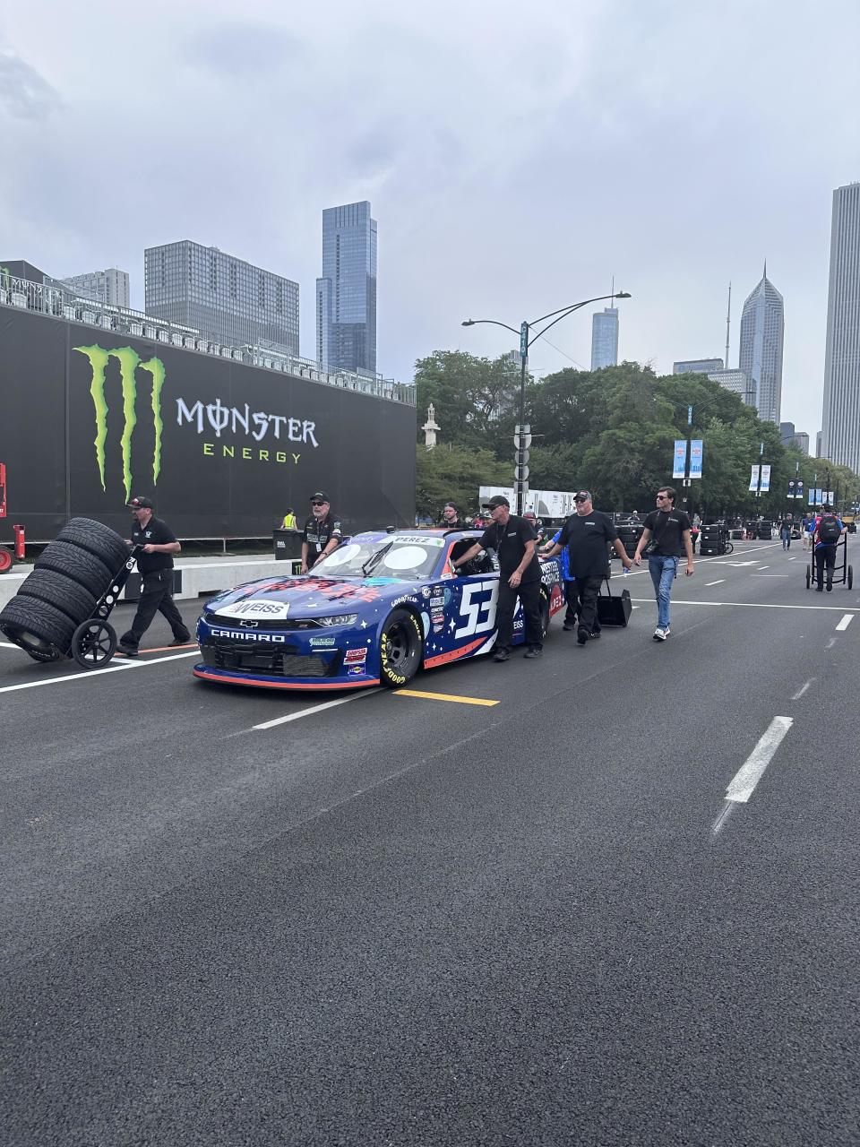 In the bustling atmosphere of Grant Park, dedicated crews position their racing vehicles for some of the final rounds of inspections.  / Credit: Analisa Novak/CBS News