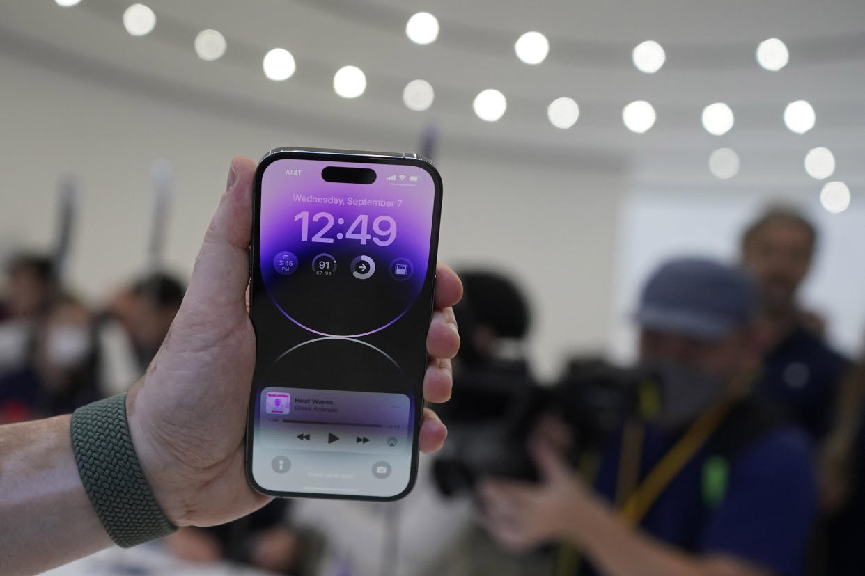 A person holds a new iPhone 14 Pro at an Apple event on the campus of Apple's headquarters in Cupertino, Calif., Wednesday, Sept. 7, 2022. (AP Photo/Jeff Chiu)