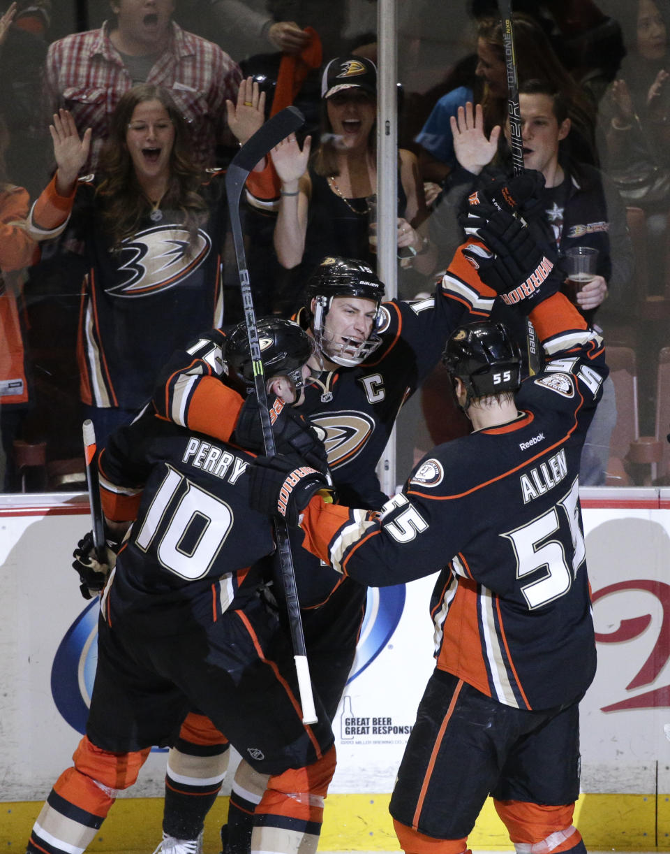 Anaheim Ducks' Ryan Getzlaf (15) celebrates his goal with Corey Perry (10) and Bryan Allen (55) during the first period in Game 2 of the first-round NHL hockey Stanley Cup playoff series against the Dallas Stars on Friday, April 18, 2014, in Anaheim, Calif. (AP Photo/Jae C. Hong)