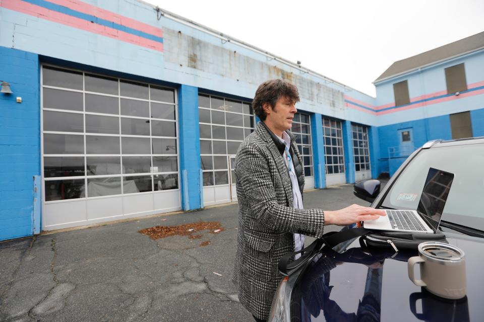 Mark Parsons queues up some information as he shares his plans for New Bedford Research & Robotics, the industrial robotics business he looks to open at the former Glaser Glass site on Purchase Street in New Bedford.
