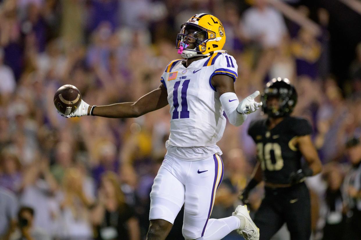 Oct 21, 2023; Baton Rouge, Louisiana, USA; LSU Tigers wide receiver Brian Thomas Jr. (11) celebrates a touchdown against Army Black Knights defensive back Cameron Jones (10) during the first quarter at Tiger Stadium. Mandatory Credit: Matthew Hinton-USA TODAY Sports