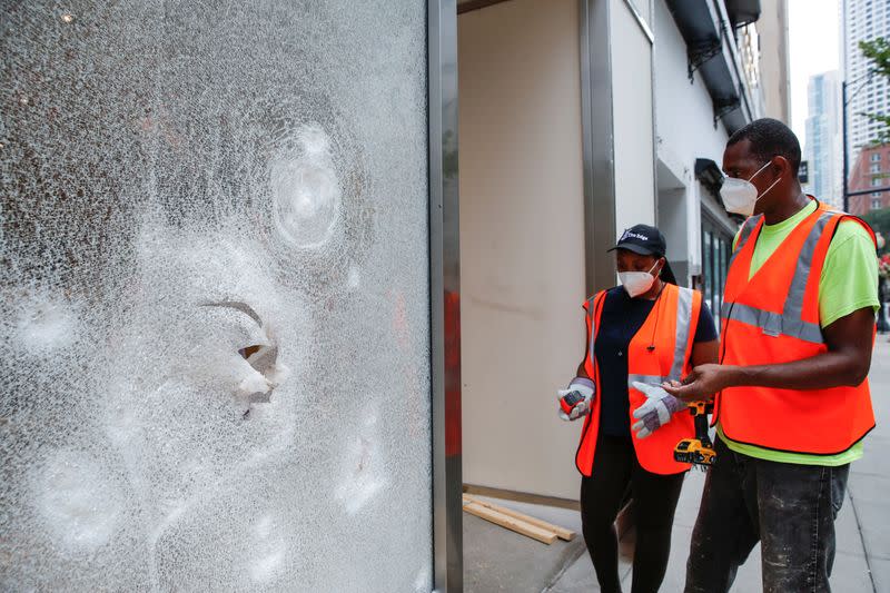 Workers clean up a looted shop in Chicago