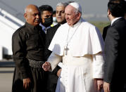 Pope Francis arrives at Irbil airport, Iraq, Sunday, March 7, 2021. Pope Francis arrived in northern Iraq on Sunday, where he planned to pray in the ruins of churches damaged or destroyed by Islamic State extremists and celebrate an open-air Mass on the last day of the first-ever papal visit to the country. (AP Photo/Hadi Mizban)