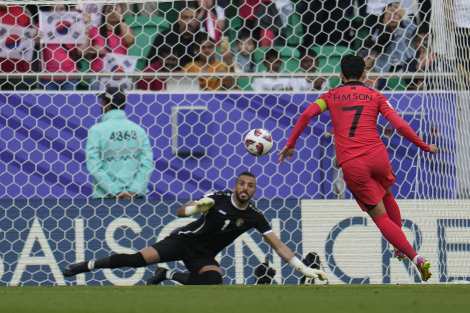 South Korea's Son Heung-min scores a penalty, the opening goal of his team, during the Asian Cup Group E soccer match between Jordan and South Korea at Al Thumama in Doha, Qatar, Saturday, Jan. 20, 2024. (AP Photo/Aijaz Rahi)