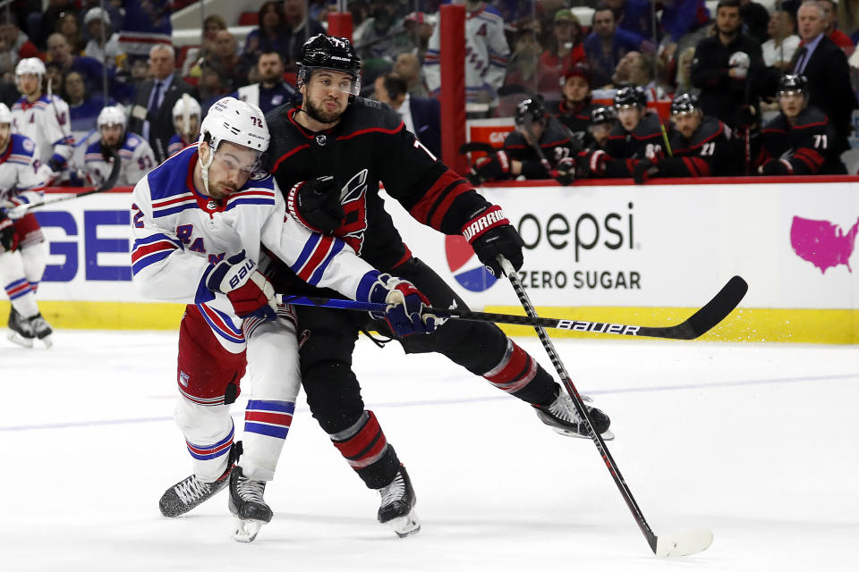 Carolina Hurricanes' Tony DeAngelo (77) collides with New York Rangers' Filip Chytil (72) during the third period of Game 2 of an NHL hockey Stanley Cup second-round playoff series in Raleigh, N.C., Friday, May 20, 2022. (AP Photo/Karl B DeBlaker)