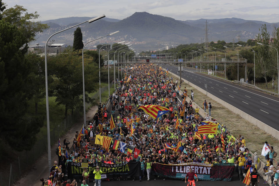 Protesters match into the city on the fifth day of protests over the conviction of a dozen Catalan independence leaders in Barcelona, Spain, Friday, Oct. 18, 2019. (Photo: Manu Fernandez/AP)