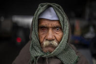 90-year old Mahavir Singh stands for a photograph as he participates in a protest against new farm laws at the Delhi-Uttar Pradesh state border, India, Friday, Jan. 8, 2021. (AP Photo/Altaf Qadri)