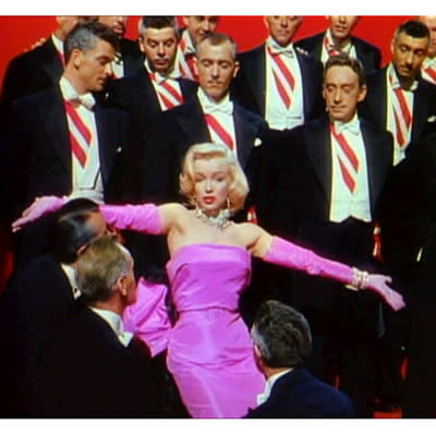 <div class="caption-credit"> Photo by: 20thCentFox/Courtesy Everett /Everett Collection</div><div class="caption-title">Marilyn Monroe, Gentlemen Prefer Blondes</div>Oh sure, there's the white halter/steam vent dress. But, Marilyn never looked better - or more in her element - than dripping in diamonds and men in this floor-length, shocking pink, satin frock created by costume designer William Travilla and matching pink gloves as Lorelei Lee. Later copied by Madge herself in the "Material Girl" video, the original sold at auction for $310,000 in 2010. (And yes, ladies, this is the only time a large ass-bow has ever worked).