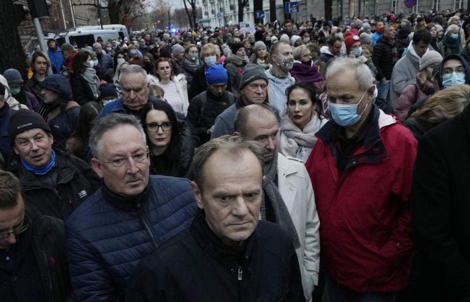 Former European Union leader Donald Tusk, foreground, now leader of Poland's opposition, takes part in a massive protest in Warsaw, Poland, Saturday, Nov. 6, 2021, against Poland's restrictive abortion law that critics say is responsible for the death last month of a 30-year-old woman with a troubled pregnancy. (AP Photo/Czarek Sokolowski)