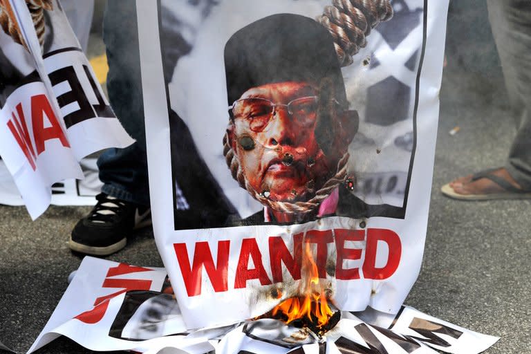 Malaysian demonstrators burn a poster of self-proclaimed Philippine Sultan Jamalul Kiram III during a protest outside the Philippine embassy in Kuala Lumpur, on March 7, 2013, against the followers of the sultan who landed on Malaysia's Borneo island on February 12 to assert a long-dormant territorial claim. Kiram has reportedly fled Malaysia, although his family insist he is still in the country