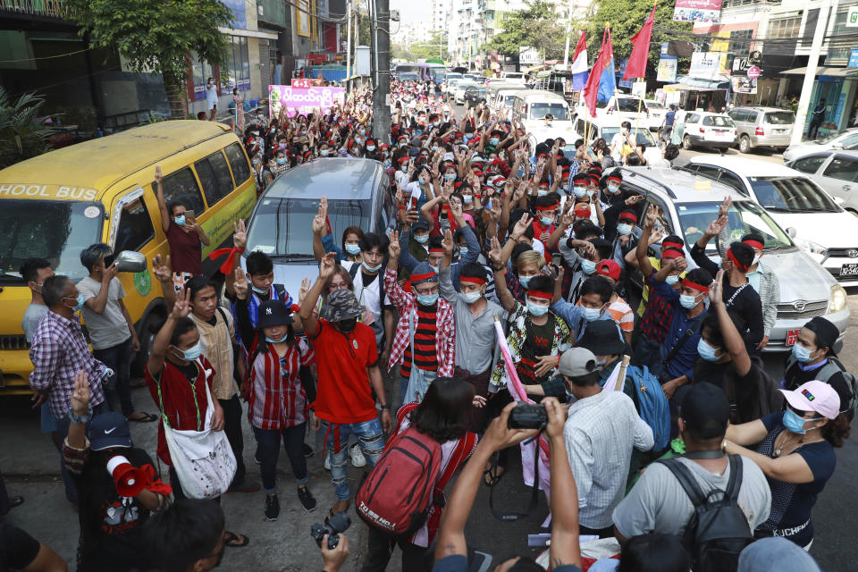 Protesters flash the three-fingered salute as they march in Yangon, Myanmar, on Feb. 6, 2021. Protests in Myanmar against the military coup that removed Aung San Suu Kyi’s government from power have grown in recent days despite official efforts to make organizing them difficult or even illegal. (AP Photo)