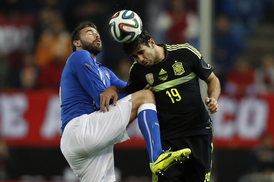 Spain's Diego Costa, right, in action with Italy’s Andrea Barzagli, left, during a international friendly soccer match between Spain and Italy at the Vicente Calderon stadium in Madrid, Spain, Wednesday, March 5, 2014. (AP Photo/Andres Kudacki)