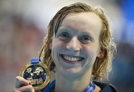 Katie Ledecky of the U.S. poses with her gold medal after the women's 1500m freestyle final at the Aquatics World Championships in Kazan, Russia, August 4, 2015. REUTERS/Hannibal Hanschke
