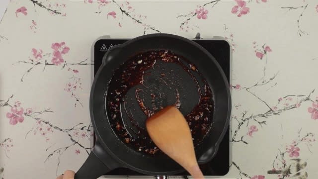 Cooked lap mei fan sauce in frying pan