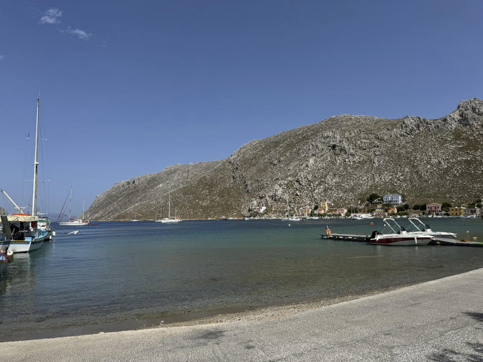 The small village of Pedi, where some reports indicate missing British doctor and TV presenter Michael Mosley was sighted, is seen on the southeastern Aegean Sea island of Symi, Greece, Friday, June, 7, 2024. Mosley went missing on Wednesday afternoon while on vacation on Symi, and authorities said a search and rescue operation that continued on Friday had found no trace of him. (AP Photo/Antonis Mystiloglou)