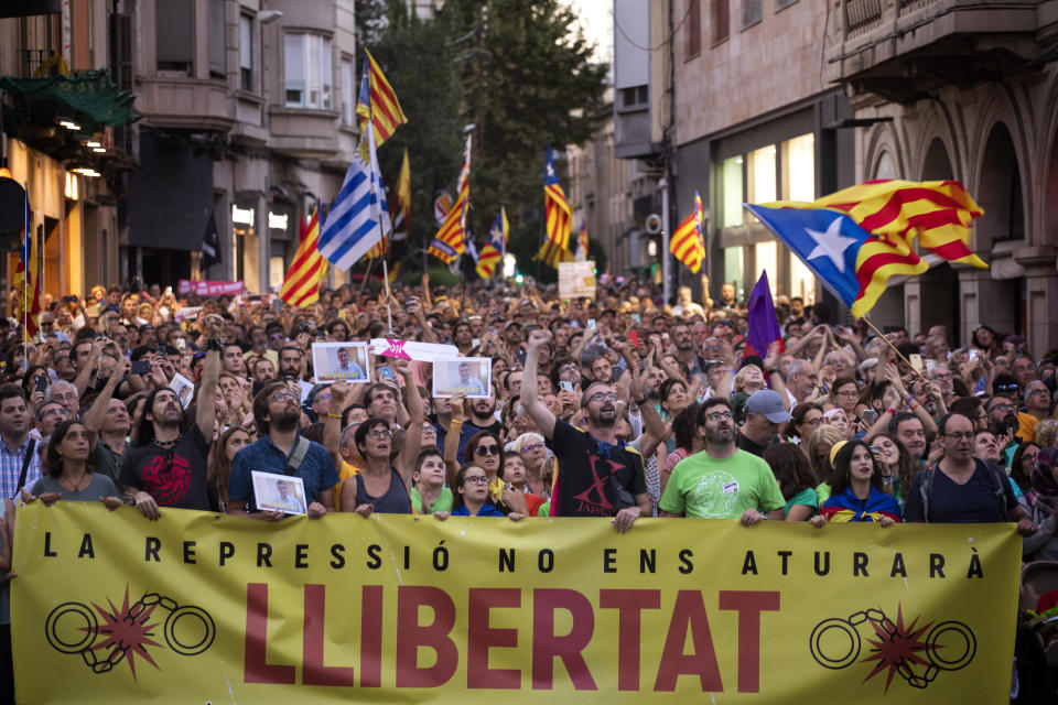 Pro-independence demonstrators march during a protest in Sabadell, near Barcelona, Spain, Saturday, Sept. 28, 2019. Several thousand people have marched in a town near Barcelona to protest the jailing of seven Catalan separatists for allegedly planning to commit violent acts of terrorism with explosives. The banner reads in Catala "The repression will not stop us. Freedom". (AP Photo/Emilio Morenatti)