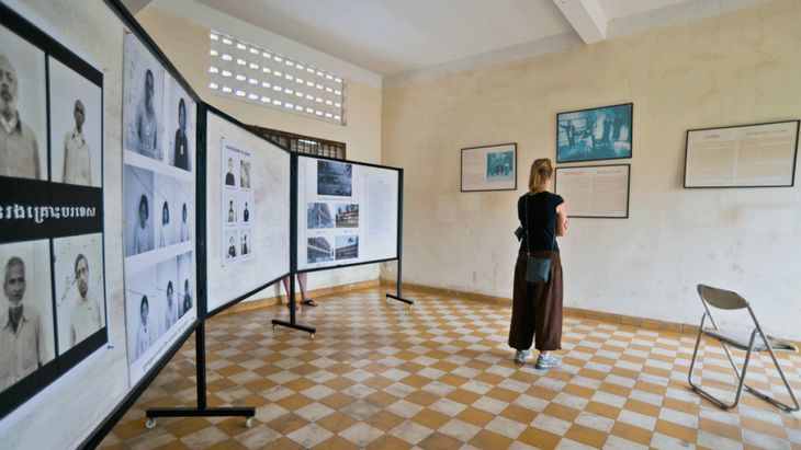 Woman at the Tuol Sleng Museum learning about the history of Cambodia