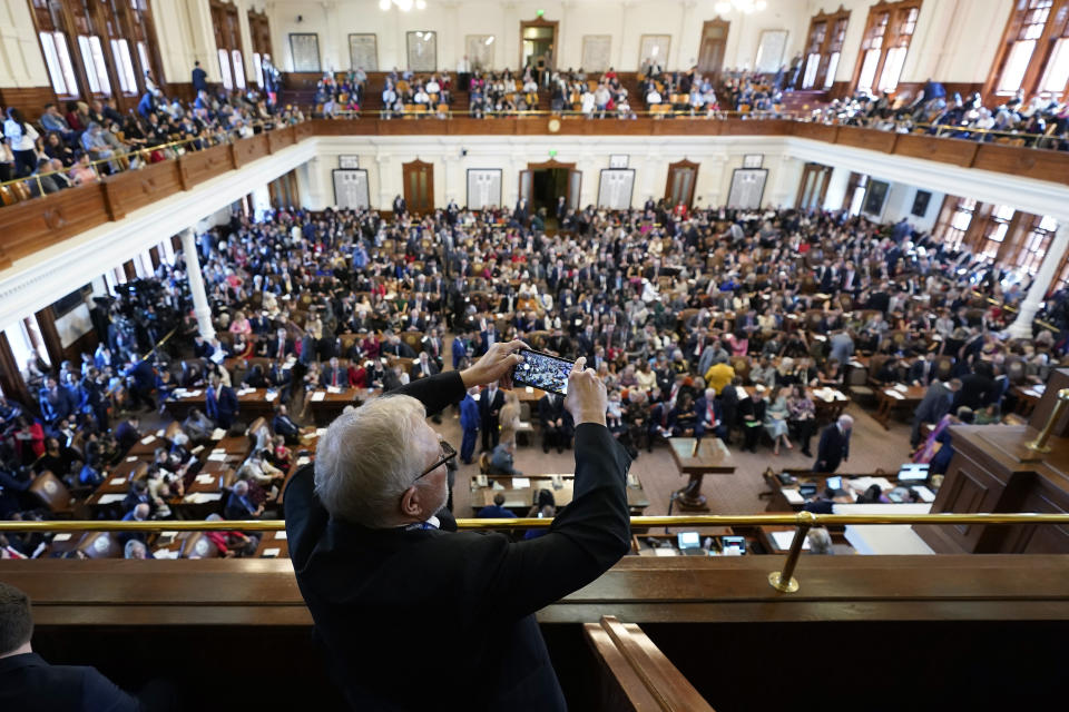 Michael Hailey photographs the House Chamber at the Texas Capitol on the first day of the 88th Texas Legislative Session in Austin, Texas, Tuesday, Jan. 10, 2023. (AP Photo/Eric Gay)