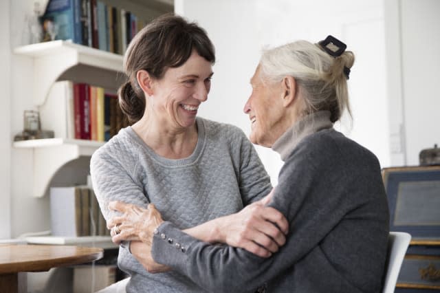 two generation women laughing together