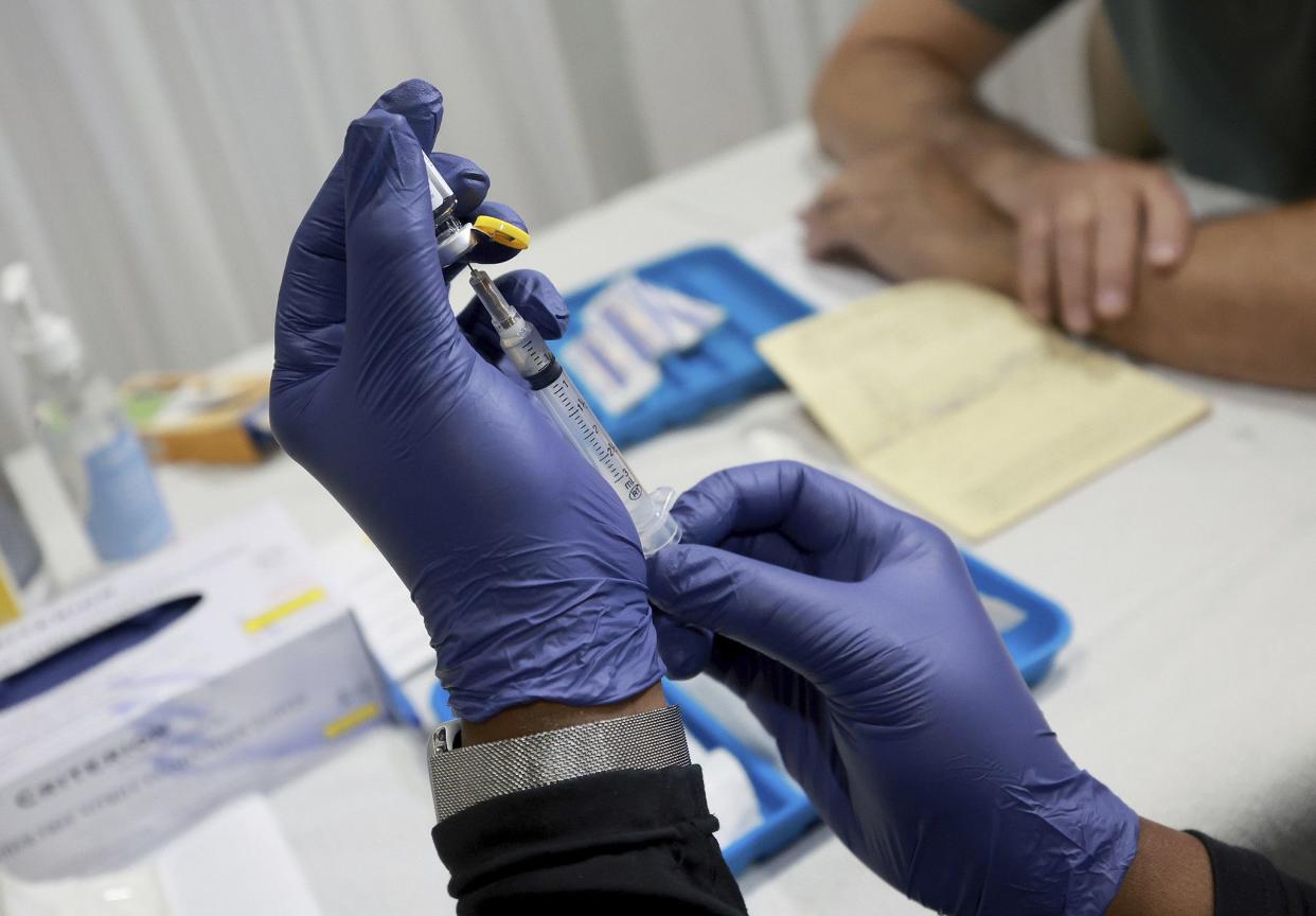 A healthcare worker prepares to administer a vaccine to a person for the prevention of monkeypox the Pride Center on July 12, 2022 in Wilton Manors, Florida. 