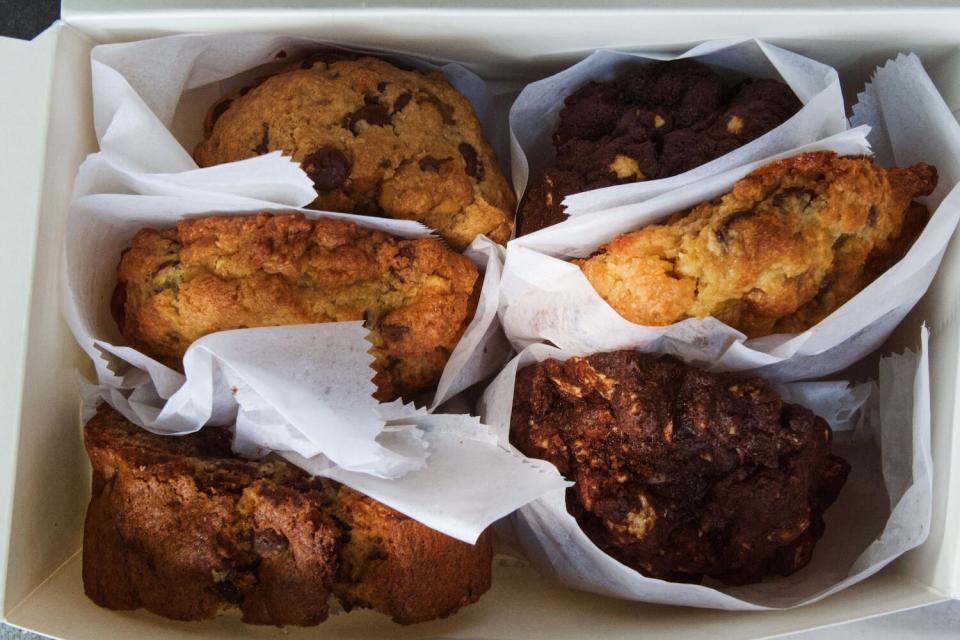 An overhead photo of a box of paper-wrapped cookies