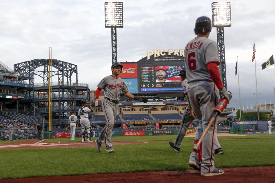 Washington Nationals' Adam Eaton, center, scores on a ground ball to third by Howie Kendrick as on-deck batter Anthony Rendon (6) watches in the first inning of a baseball game against the Pittsburgh Pirates, Thursday, Aug. 22, 2019, in Pittsburgh. (AP Photo/Keith Srakocic)