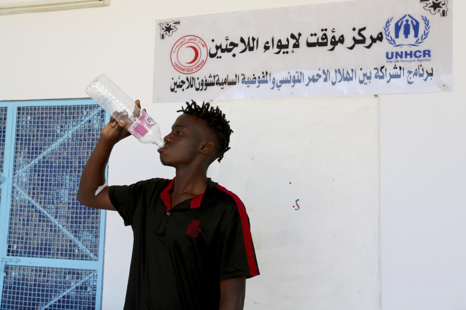 A Malian survivor of a shipwreck drinks in the Red Crescent center of Zarzis, southern Tunisia, Thursday, July 4, 2019. The U.N. migration agency says a boat carrying 86 migrants from Libya sank in the Mediterranean overnight, and just three people on board survived, with 82 missing. The shipwreck late Wednesday off the Tunisian city of Zarzis came a day after a deadly airstrike on a Libyan detention center that killed at least 44 migrants.(AP Photo/Sami Jelassi)