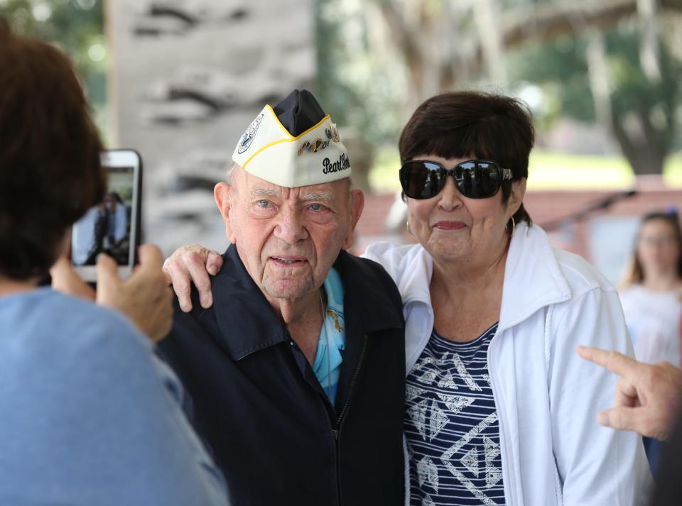 Pearl Harbor survivor Jack Edge gets his picture taken with Julie Edge, his daughter-in-law, as veterans are honored during the Pearl Harbor Remembrance Ceremony at the Ocala-Marion County Veterans Memorial Park in Ocala on Dec. 8, 2018.