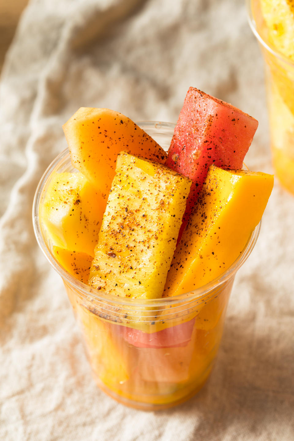 A fruit cup with tajin seasoning.