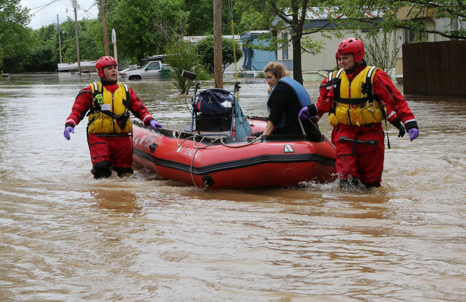 Fire department members with woman on boat