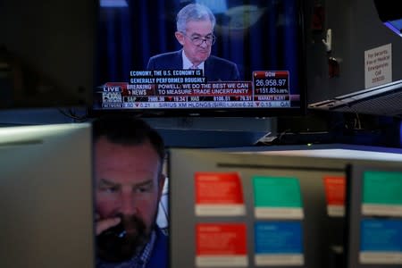 A trader works as a screen shows Federal Reserve Chairman Jerome Powell's news conference after the U.S. Federal Reserve interest rates announcement on the floor of the NYSE in New York