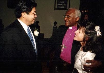 In 1999, Archbishop Desmond Tutu, center, officiated the wedding of his friends Stewart Ting Chong and Marsha Minasian at St. John’s Episcopal Church in Hingham.