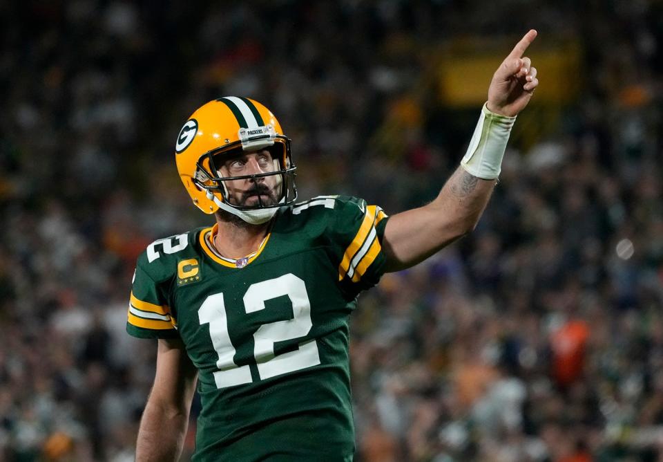 Green Bay Packers quarterback Aaron Rodgers celebrates after rushing for a first down.