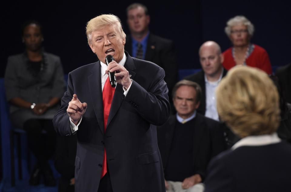 Republican presidential nominee Donald Trump speaks as Democratic U.S. presidential nominee Hillary Clinton listens during their presidential town hall debate at Washington University in St. Louis, Mo., on Oct. 9, 2016. (Saul Loeb/Pool/Reuters