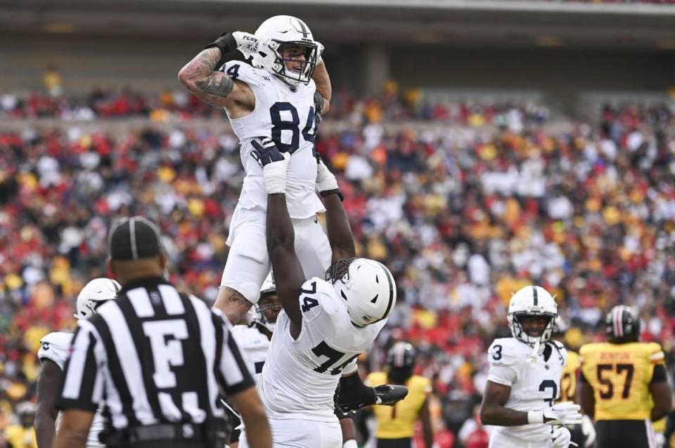 Penn State offensive lineman Olumuyiwa Fashanu (74) celebrates with tight end Theo Johnson (84) after scoring a first half touchdown against Maryland at SECU Stadium in November 2023.