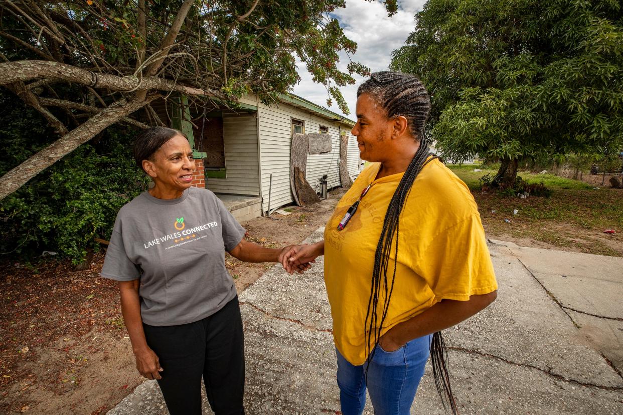 Dorothy Scott Wilson, left, greets Nashena Walker in front of the Colvin House on D Street in Lake Wales. Walker, who owns the home, is the great-granddaughter of Donnie and Anna Colvin, the original inhabitants. Wilson, a local historian, is pushing for restoration of the 1920 house, which was recommended for demolition last year by the Lake Wales Code Enforcement Board.