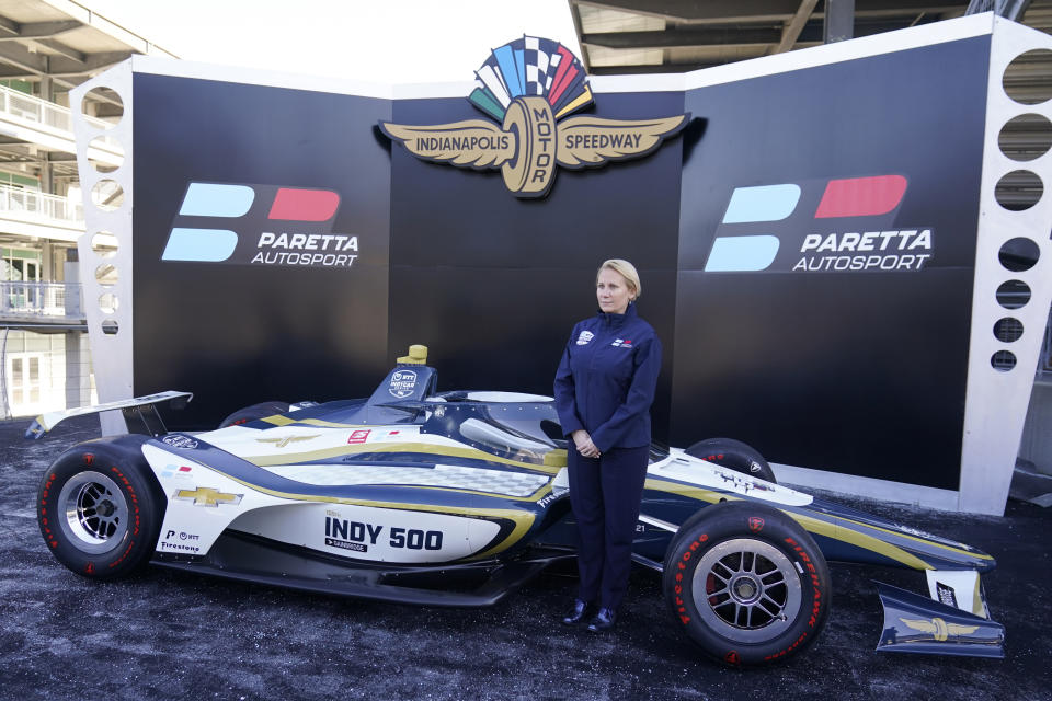 Beth Paretta poses on the victory podium following a news conference at the Indianapolis Motor Speedway, Tuesday, Jan. 19, 2021, in Indianapolis. Paretta and Swiss driver Simona de Silvestro are teaming up to put a women-run race team in this year's Indianapolis 500. (AP Photo/Darron Cummings)